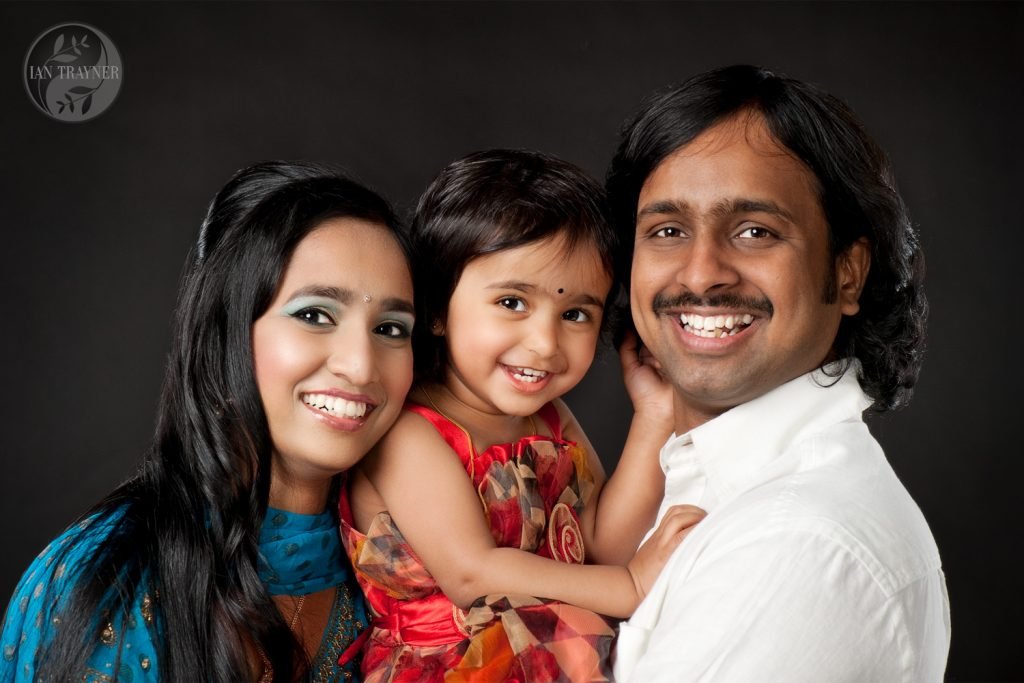 Happy asian family photographed in my studio. Parents and cute daugher.