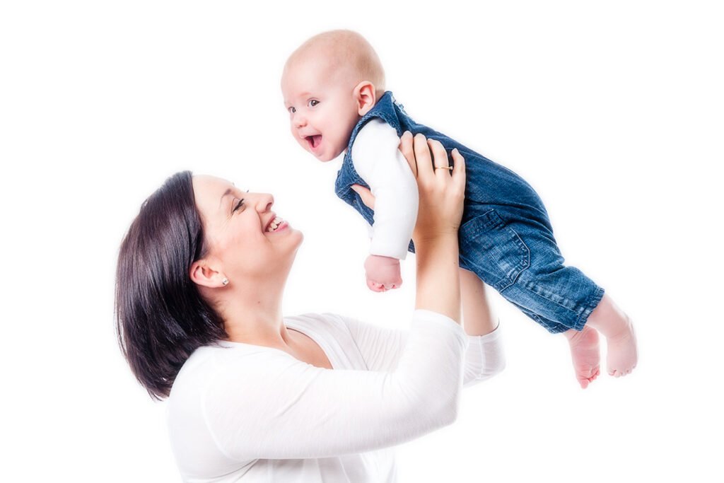 mother and baby laughing and smiling, white background photography